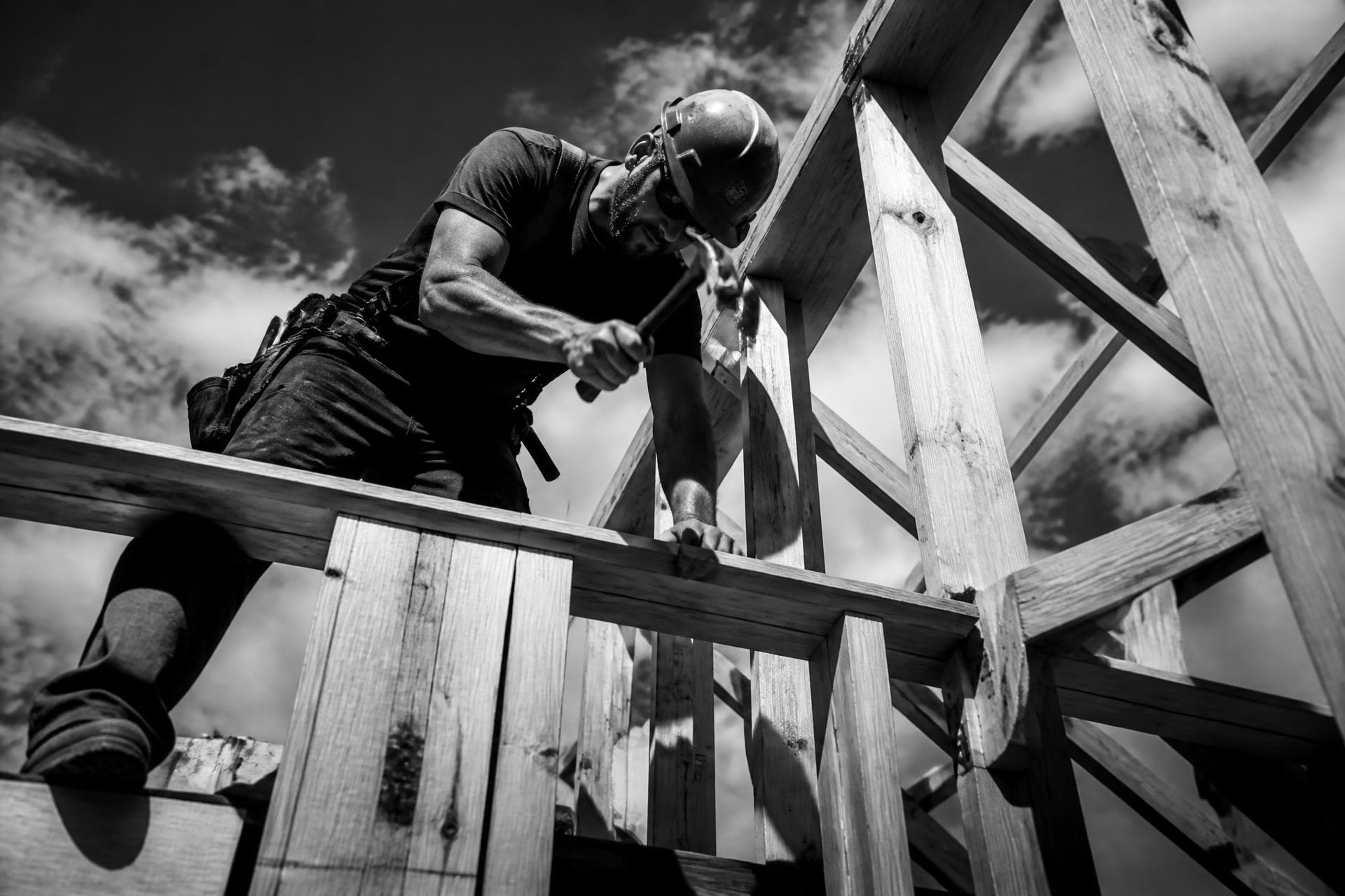 Contractor framing a roof structure on a job site